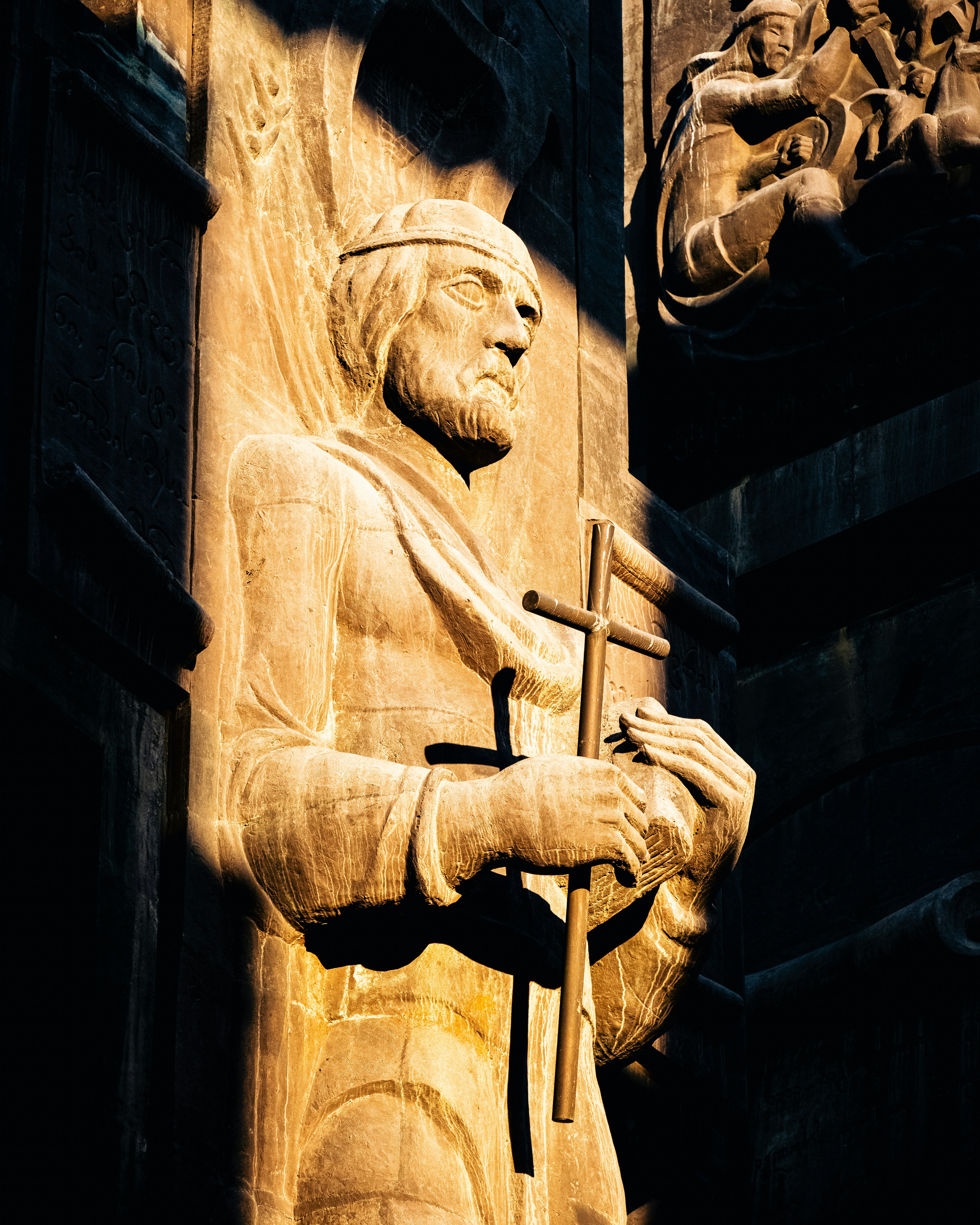 Illuminated carved figure holding a cross at the Chronicle of Georgia